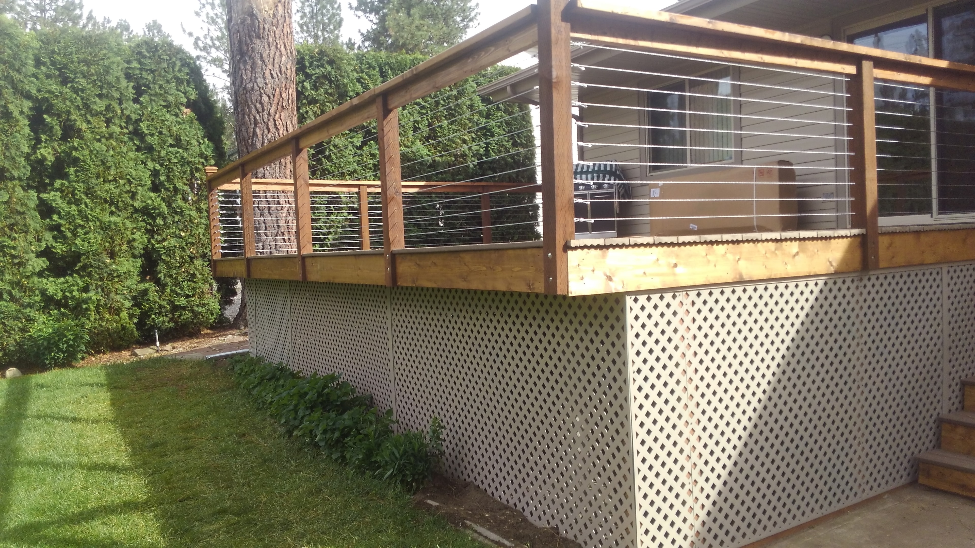 Cedar posts with solar post caps on cable railing deck