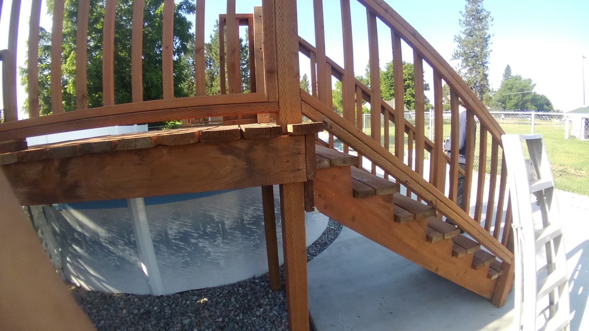 Cedar deck platform next to above-ground pool